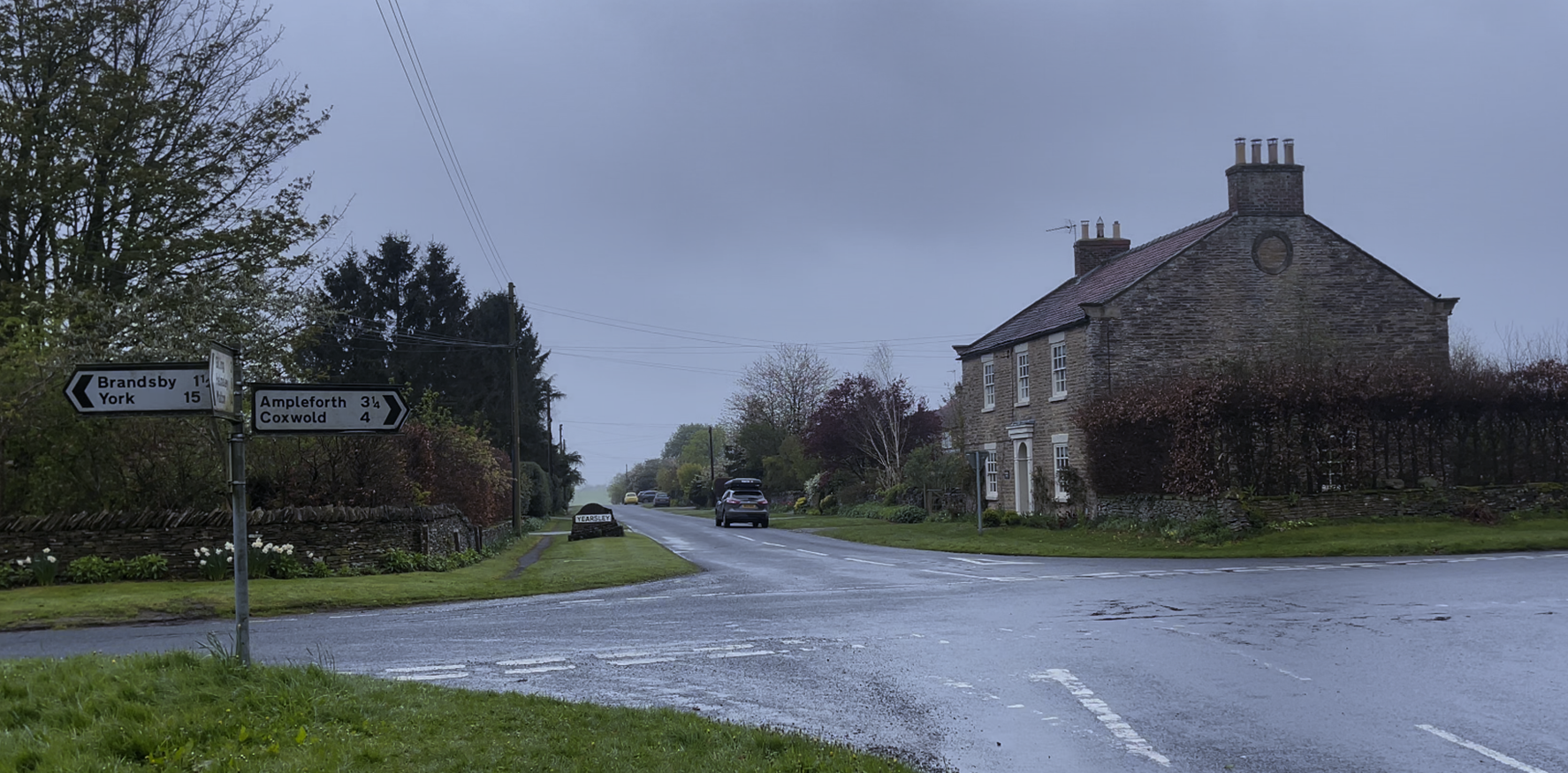 A road with cars on it
Description automatically generated